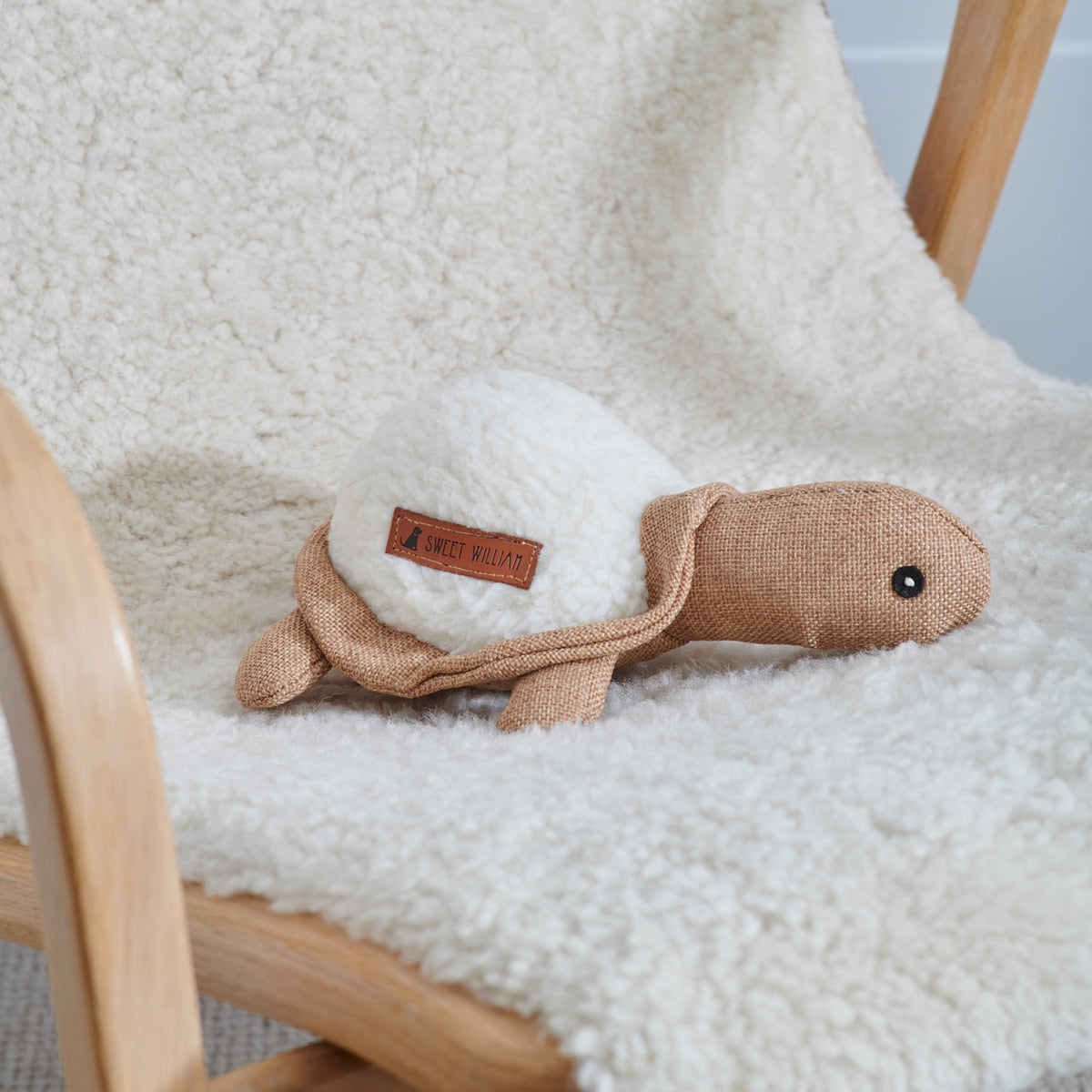 Horatio the Turtle dog toy on a fluffy chair — soft fabric squeaky toy for small dogs and puppies by Sweet William Designs