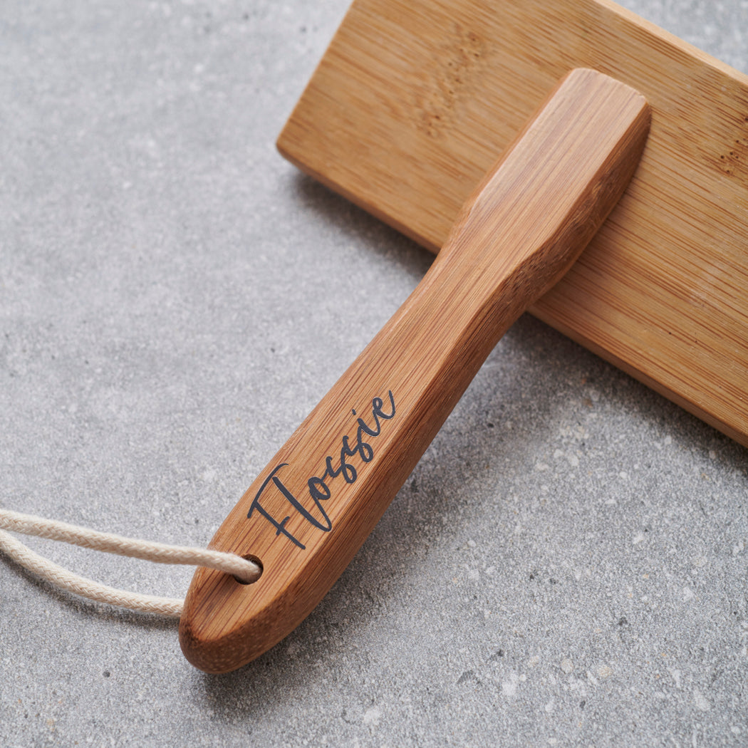 Close-up of bamboo slicker brush handle personalised with name in script — dog grooming gift by Sweet William Designs