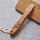 Close-up of bamboo slicker brush handle personalised with name in script — dog grooming gift by Sweet William Designs