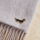 Close-up of Dachshund enamel pin attached to a wool scarf — gold-plated dog lover gift by Sweet William Designs