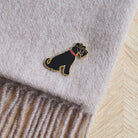 Close-up of Black Schnauzer enamel pin attached to a wool scarf — gold-plated dog pin by Sweet William Designs