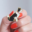 Close-up of a Border Collie enamel pin held in hand, showing the detailed Border Collie dog design by Sweet William Designs