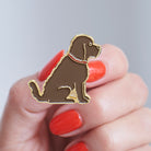 Close-up of Chocolate Cockapoo / Labradoodle enamel pin held in hand, showing the detailed Cockapoo / Labradoodle dog design by Sweet William Designs 