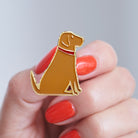 Close-up of a Fox Red Labrador enamel pin held in hand, showing the detailed Labrador illustration by Sweet William Designs
