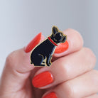 Close-up of a French Bulldog enamel pin held in hand, showing the detailed French Bulldog illustration by Sweet William Designs