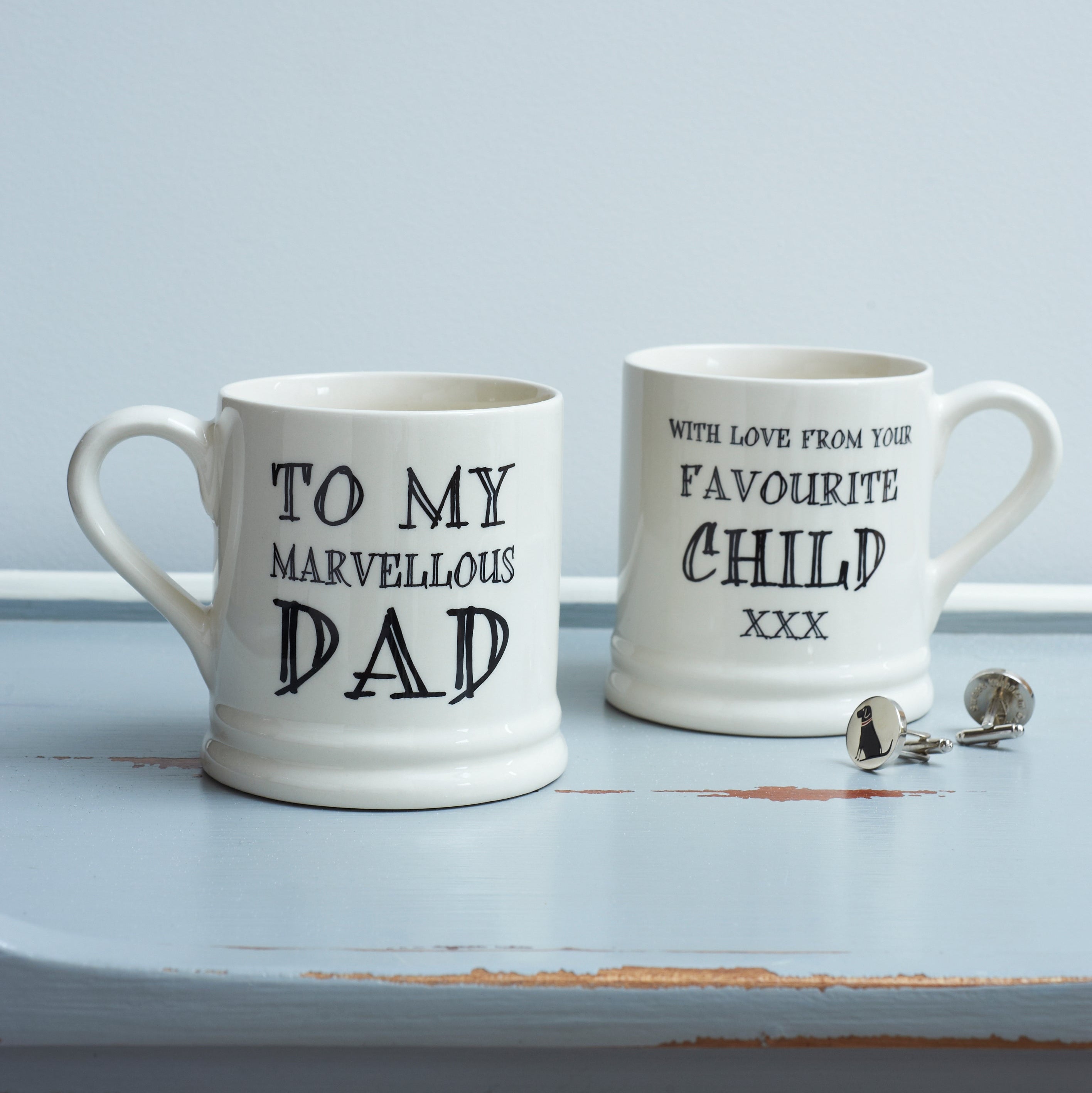 Ceramic Dad mug showing “To My Marvellous Dad” on the front and “With Love From Your Favourite Child xxx” on the reverse, styled with Labrador silver cufflinks by Sweet William Designs