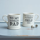 Ceramic Dad mug showing “To My Marvellous Dad” on the front and “With Love From Your Favourite Child xxx” on the reverse, styled with Labrador silver cufflinks by Sweet William Designs