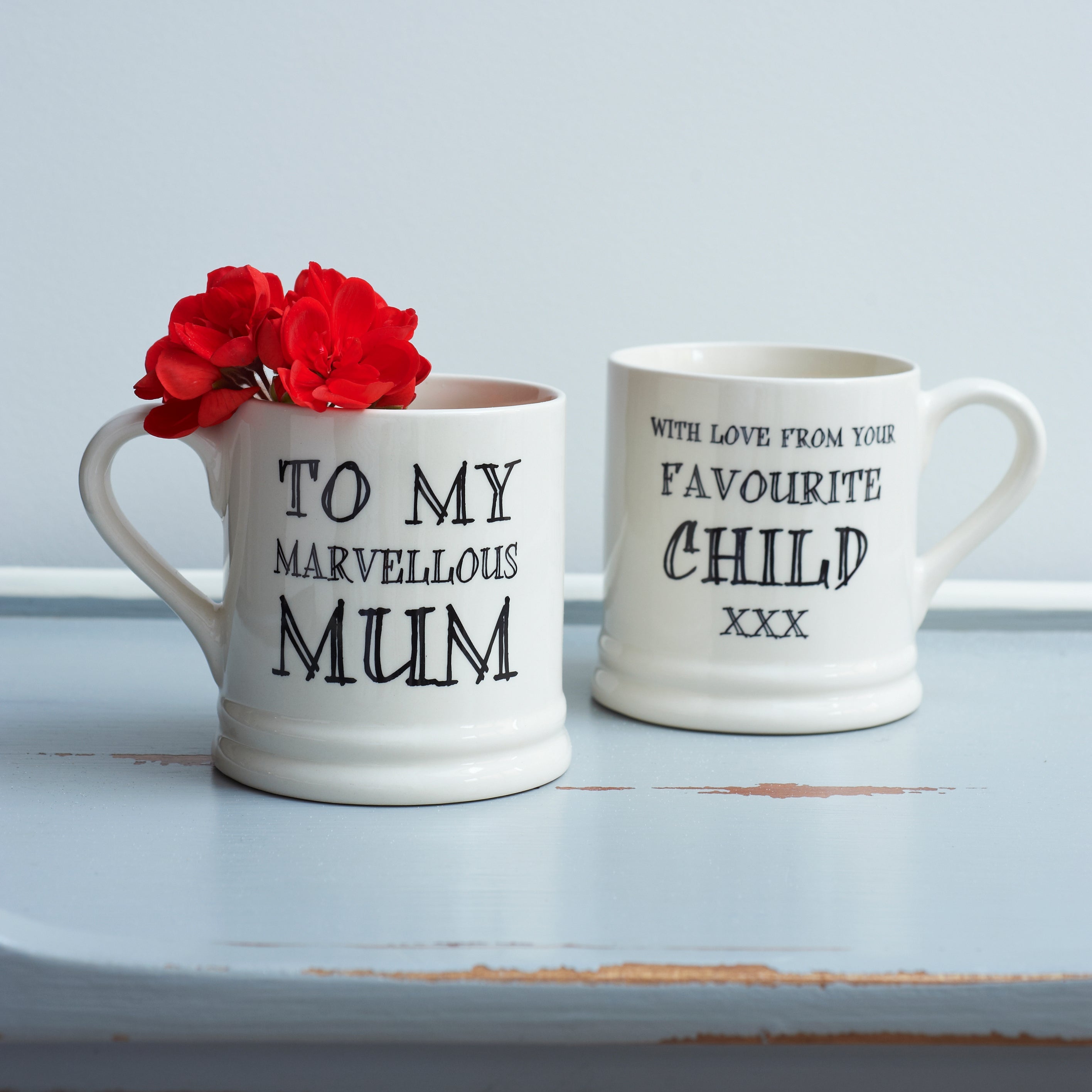 Ceramic Mum mug showing “To My Marvellous Mum” on the front and “With Love From Your Favourite Child xxx” on the reverse, a funny gift by Sweet William Designs