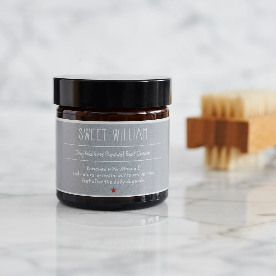 Close-up of Dog Walkers Revival Foot Cream in amber glass jar on marble surface — part of the Dog Walkers Revival Kit by Sweet William Designs
