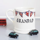 Ceramic Grandad mug with hand-drawn Union Jack bunting and two small black toy cars, a thoughtful gift for a much-loved grandfather