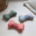 Green, grey and orange tweed dog bone toys by Sweet William, a perfect gift for the dog who loves to play