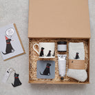 Black Labrador gift hamper featuring coaster, matching mug, socks, handcream and foot cream, beside a birthday card and keyring