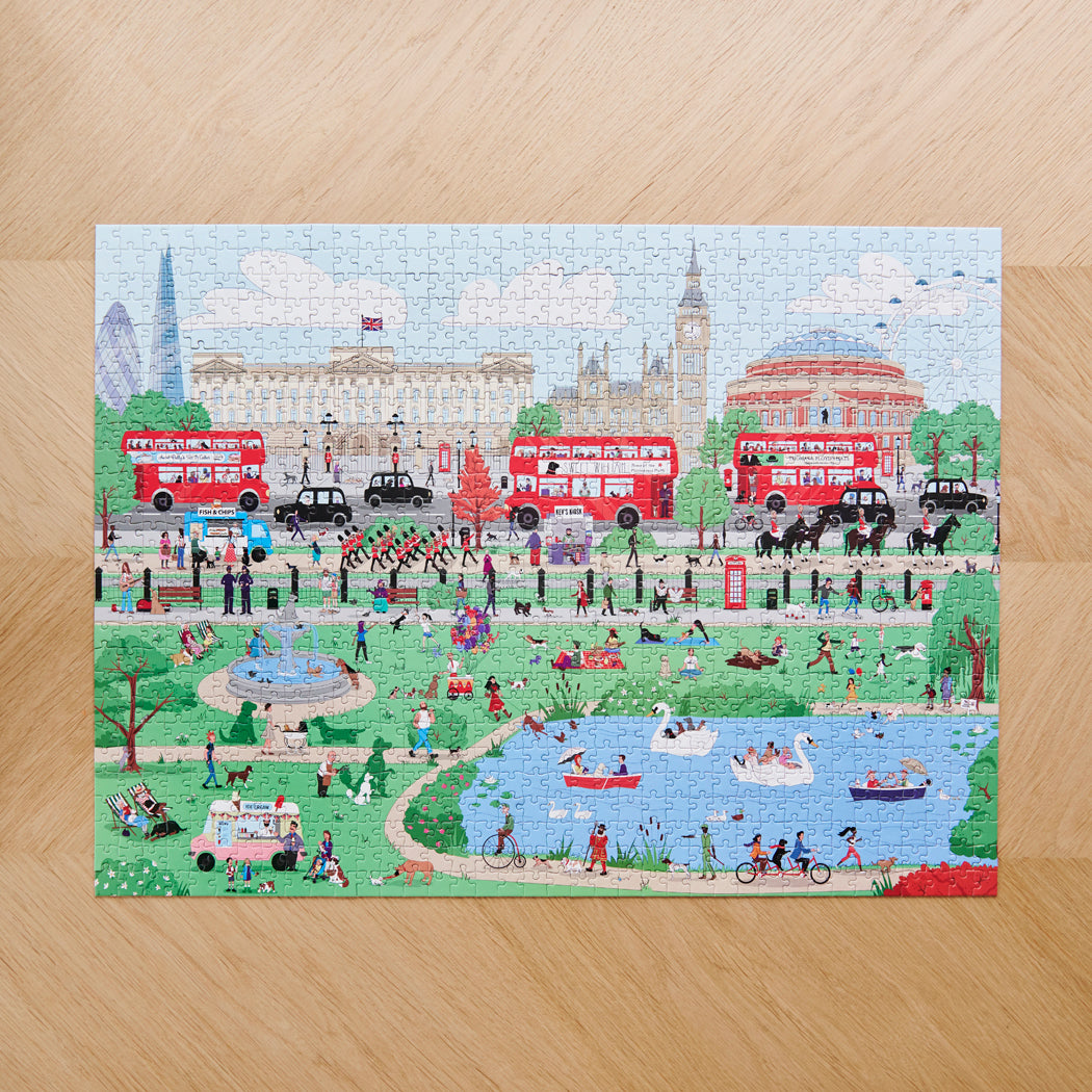 Completed Dog Walkers of London jigsaw puzzle on wooden surface — 1000 piece illustrated London scene with Buckingham Palace, Big Ben and Royal Albert Hall, dog lover gift by Sweet William Designs