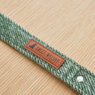 Close-up of the tag on a green tweed dog lead