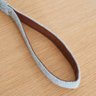 Close-up of the vegan leather-lined handle on a grey tweed dog lead