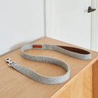 Grey tweed dog lead with vegan leather-lined handle and silver clasp