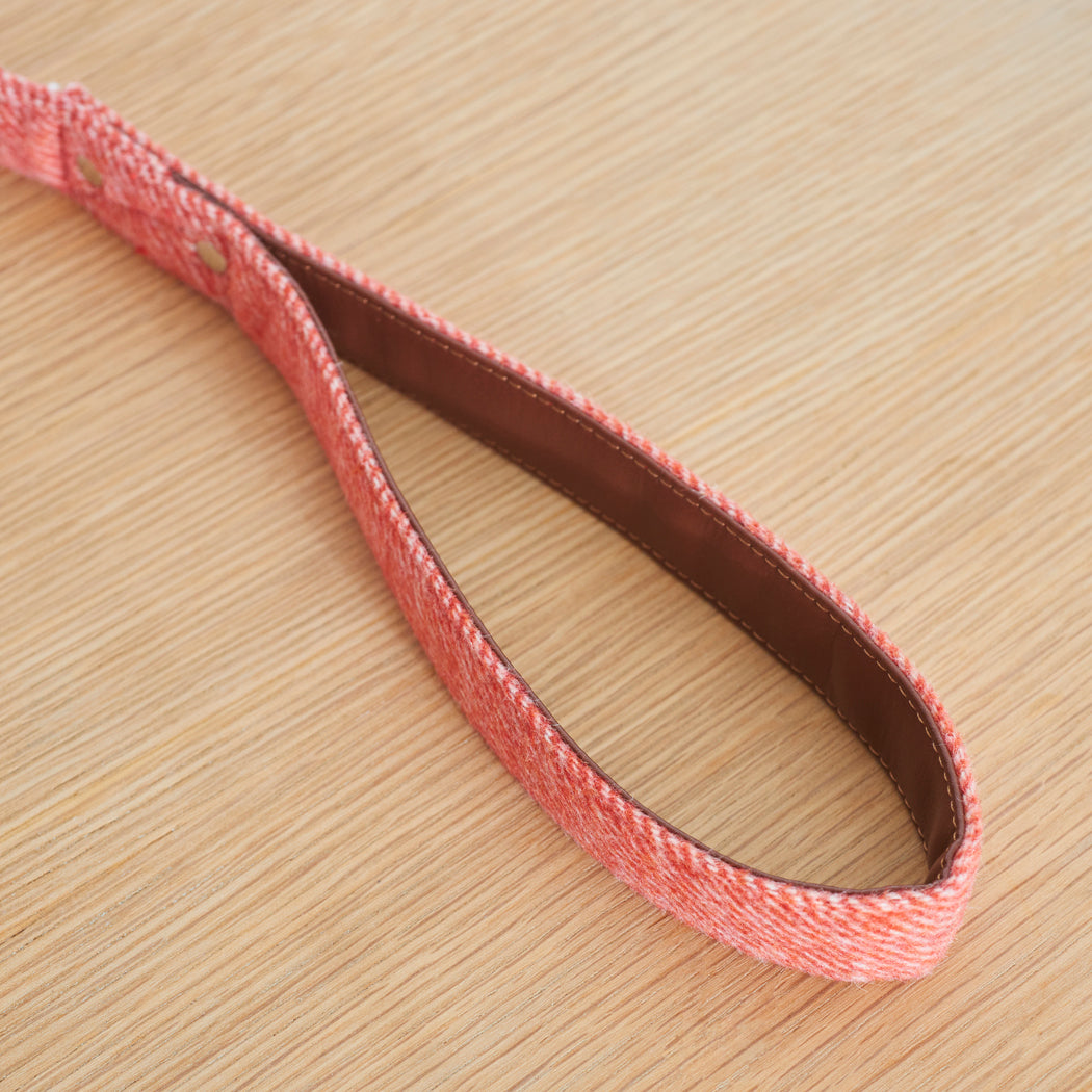 Close-up of the vegan leather-lined handle on an orange tweed dog lead