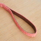 Close-up of the vegan leather-lined handle on an orange tweed dog lead