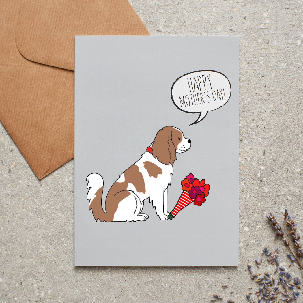 Cavalier King Charles Spaniel Mother's Day card featuring illustrated Cavalier holding flowers — blank inside, supplied with kraft envelope, by Sweet William Designs