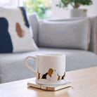 Basset Hound mug on coffee table — illustrated ceramic dog mug by Sweet William Designs