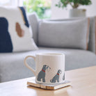 Sweet William Grey Schnauzer Mug on a coffee table — illustrated Grey Schnauzer repeat pattern ceramic mug