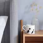 Sweet William Springer Spaniel (Black & White) Mug on a bedside table — Springer Spaniel dog lover gift mug