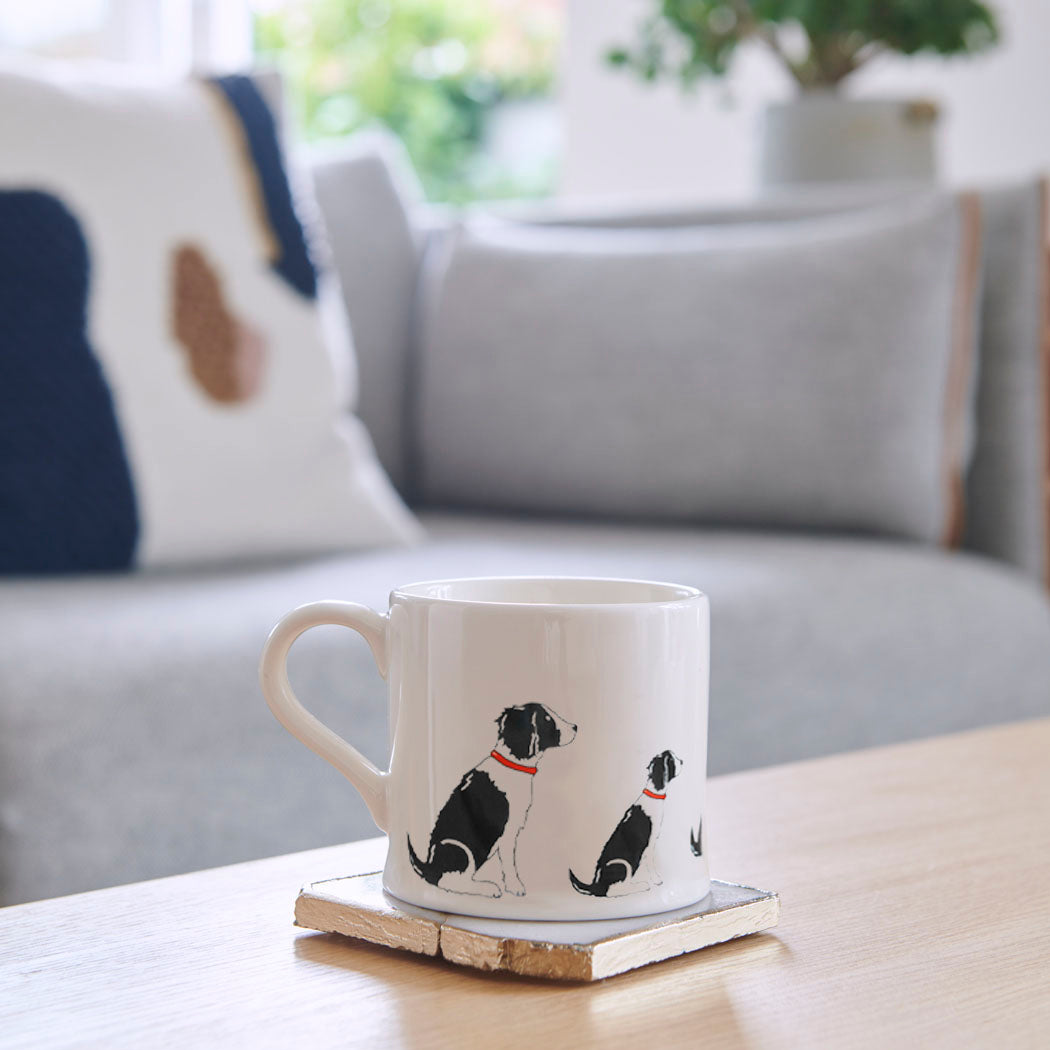 Sweet William Springer Spaniel (Black & White) Mug on a coffee table — illustrated repeat pattern ceramic mug