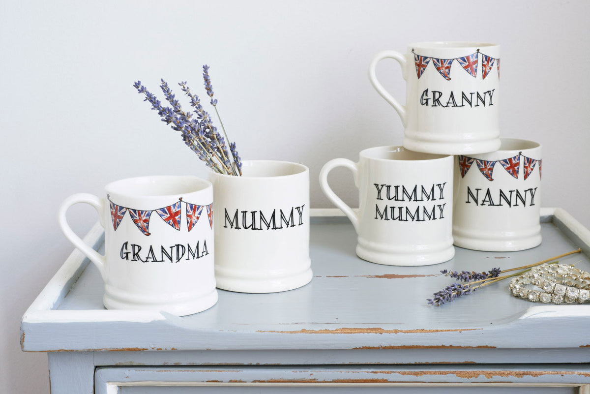 Group of ceramic Grandparent mugs arranged as thoughtful Mother’s Day gifts, featuring hand-drawn Union Jack bunting