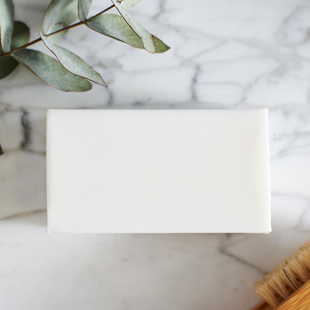 Unwrapped Chocolate Labrador triple milled soap bar on marble surface — honey-enriched luxury soap, no SLS or parabens, made in England
