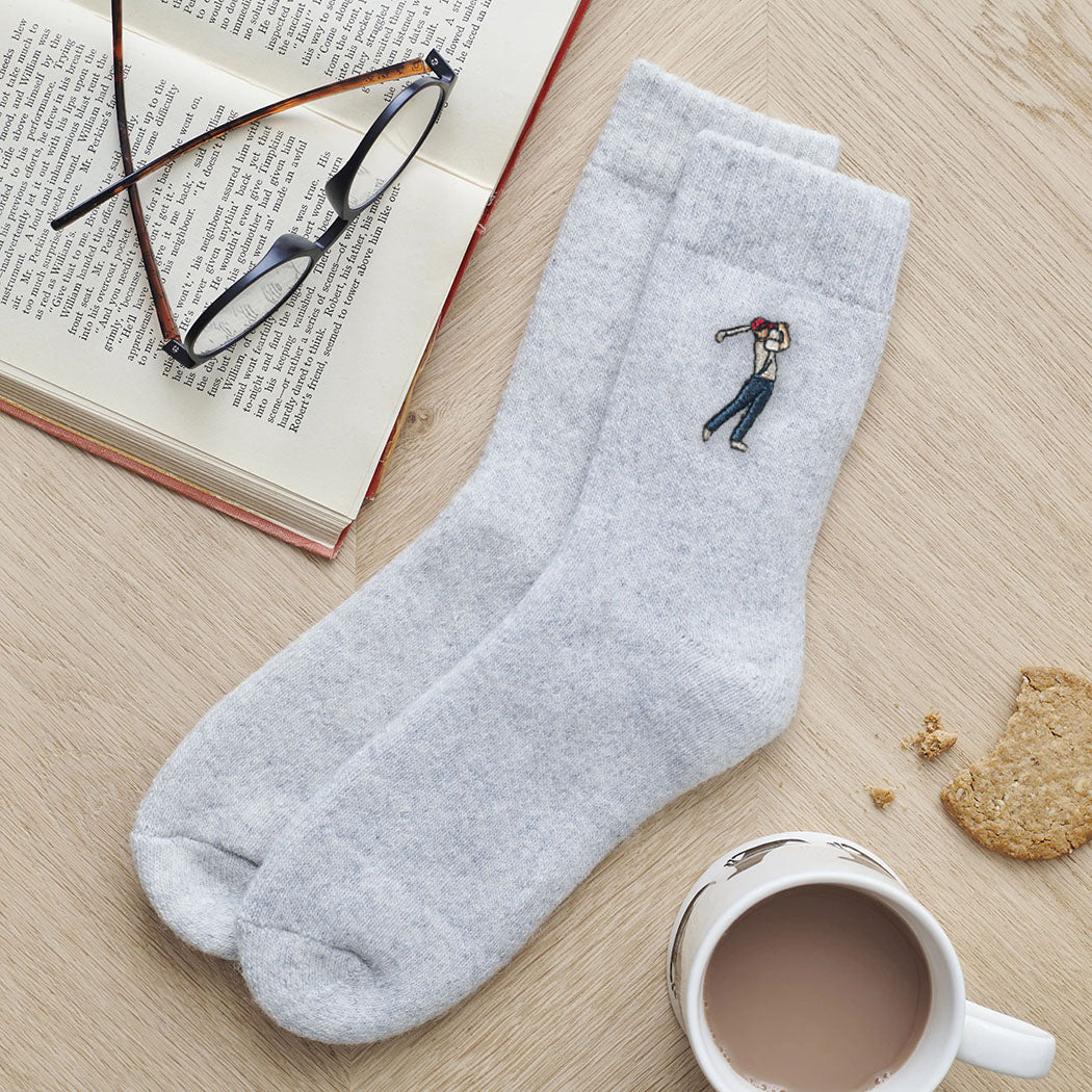 Golfer embroidered wool socks laid flat with book, glasses and cup of tea — thoughtful golf fan gift by Sweet William Designs