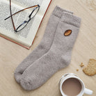 Rugby embroidered wool socks laid flat with book, glasses and cup of tea — thoughtful rugby fan gift by Sweet William Designs