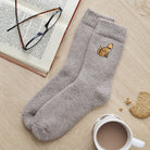 Ginger cat embroidered wool socks laid flat with book, glasses and cup of tea — cosy cat lover gift by Sweet William Designs