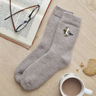 Seagull wool socks laid flat with book, glasses and cup of tea — embroidered wool blend coastal socks, thoughtful seaside gift