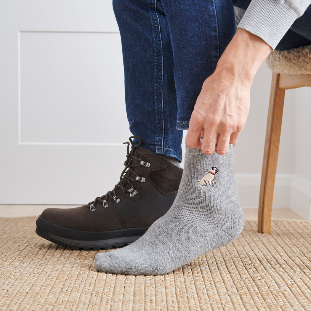 Man wearing Pug dog walking socks — embroidered wool blend, unisex gift for dog lovers