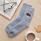 Tractor embroidered wool socks laid flat with book, glasses and cup of tea — cosy country-inspired gift by Sweet William Designs