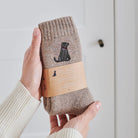 Chocolate Labrador socks in hand – embroidered wool dog lover gift