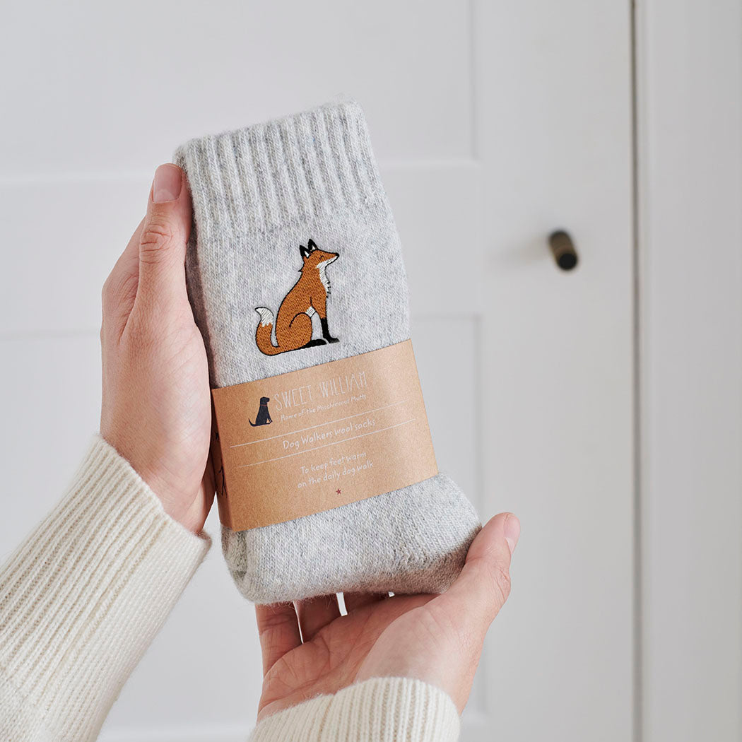Fox wool socks held in hands with Sweet William Designs branded band — soft wool blend fox lover gift