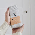 Ski wool socks held in hands with Sweet William Designs branded band — soft wool blend ski lover gift
