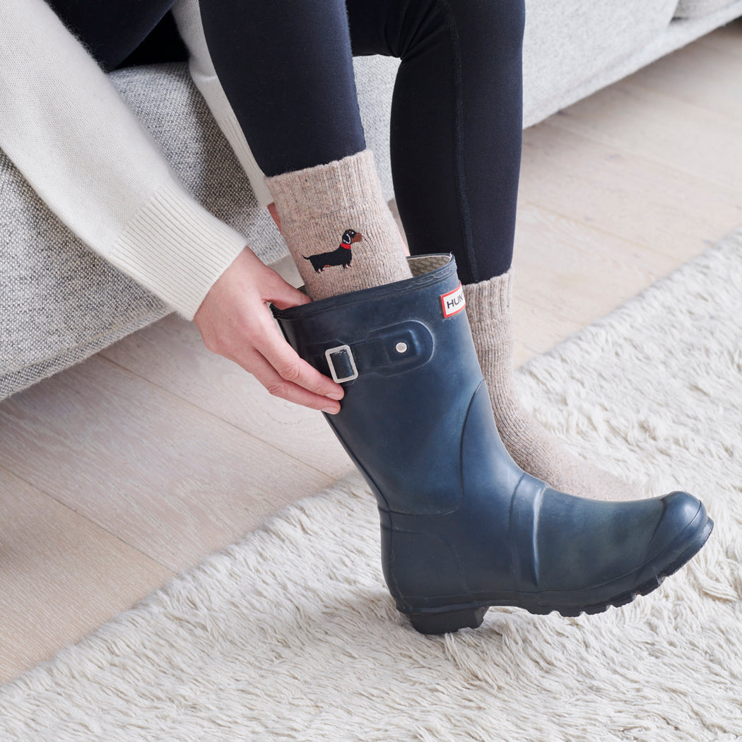 Sausage dog walking socks worn with wellies — perfect gift for dog walkers and countryside lovers