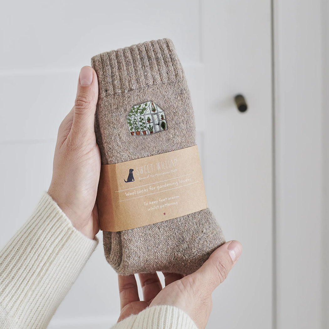 Greenhouse gardening socks held in hand — soft taupe marl wool blend with embroidered greenhouse design, gardening gift by Sweet William Designs