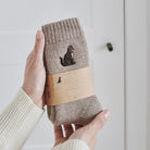 Tabby cat wool socks held in hands with Sweet William Designs branded band — soft wool blend cat lover gift