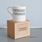 “Superhero in Disguise” mug presented on its kraft gift box, a perfect gift for a real-life superhero