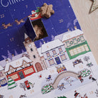 Close-up of Christmas Dog Treat Advent Calendar with a door open to reveal a star-shaped dog treat, showing the festive countdown design