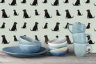Sweet William Designs Black Labrador wallpaper with blue pottery styling — repeat Labrador pattern on sage green