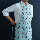 Liver & White Springer Spaniel organic cotton apron — screen-printed repeat pattern, front pocket & adjustable strap, gift for Spaniel lovers