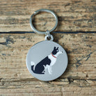 Close-up of Border Collie dog ID tag — silver-plated brass with illustrated Border Collie design, personalised dog tag by Sweet William Designs