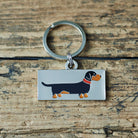 Close-up of Dachshund dog ID tag — silver-plated brass with illustrated Dachshund design, personalised dog tag by Sweet William Designs