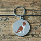 Close-up of Liver & White Springer Spaniel dog ID tag — silver-plated brass with illustrated Springer Spaniel design, personalised dog tag by Sweet William Designs
