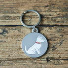 Close-up of Westie dog ID tag — silver-plated brass with illustrated Westie design, personalised dog tag by Sweet William Designs