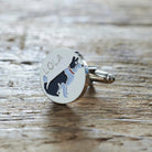 Close-up of personalised Border Collie cufflink engraved with name on rustic wood — silver-plated gift for Border Collie owners